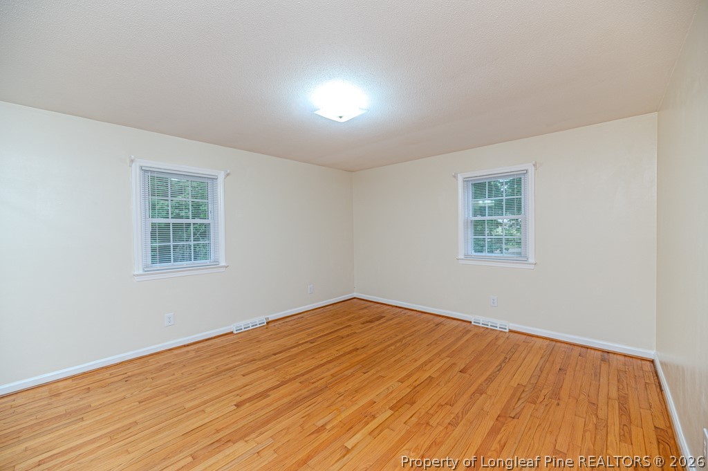 3384 Goldston Glendon Road Goldston, NC 27252 - Photo 18 of 47 a view of an empty room with wooden floor and a window