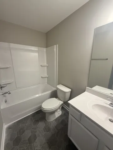 a bathroom with a sink toilet vanity and bathtub