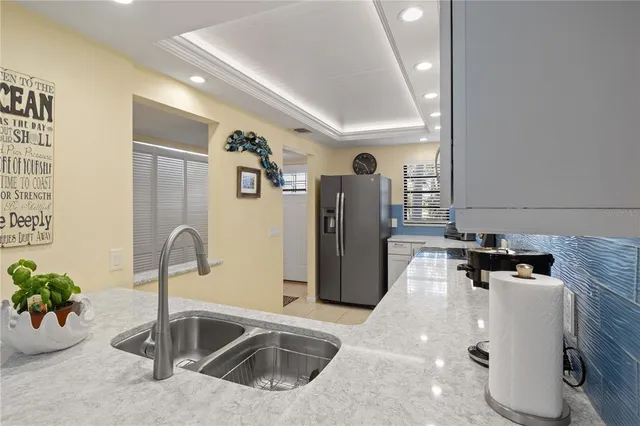 a kitchen with a sink and a refrigerator
