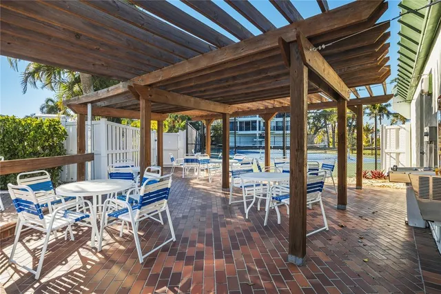a view of a patio with table and chairs and wooden floor