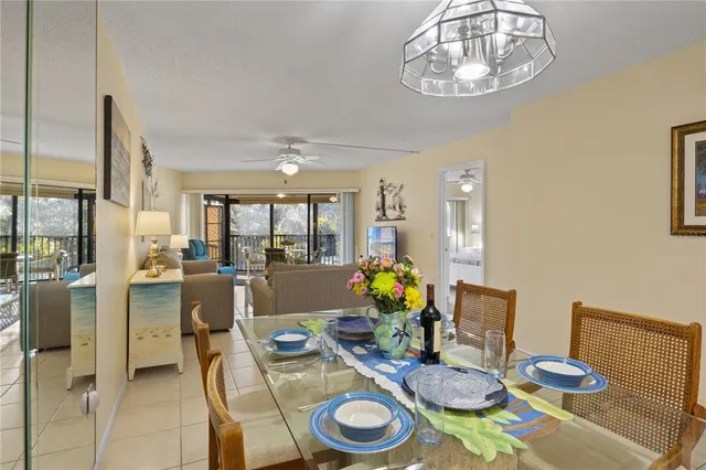 a dining room with furniture a chandelier and wooden floor