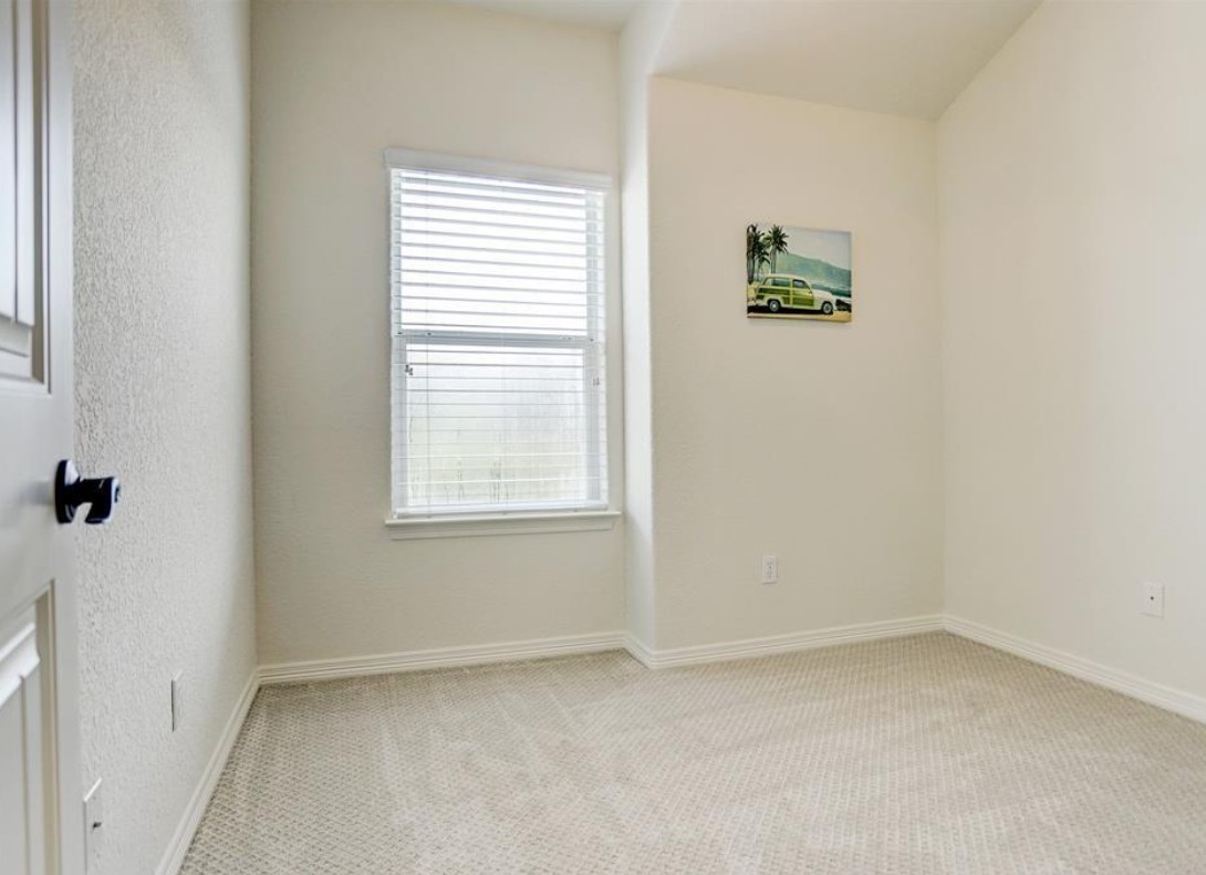 277 Capetown Conroe, TX 77356 - Photo 8 of 10 Versatile secondary bedroom featuring plush carpeting, natural light, and a flexible layout perfect for guests, a nursery, or a home office