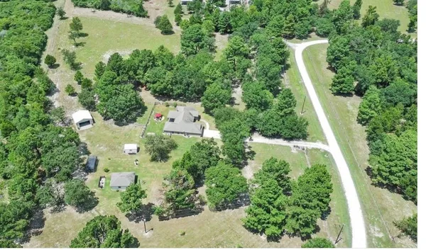 an aerial view of residential house with outdoor space and swimming pool