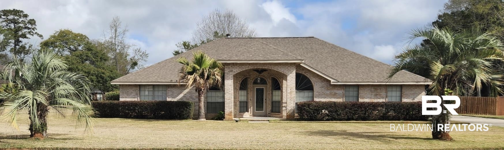 9425 Autauga Bend Daphne, AL 36526 - Photo 1 of 15 View of front of house featuring roof with shingles, brick siding, a front yard, and a porch