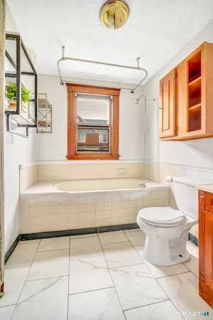 a bathroom with a toilet a sink and a bathtub
