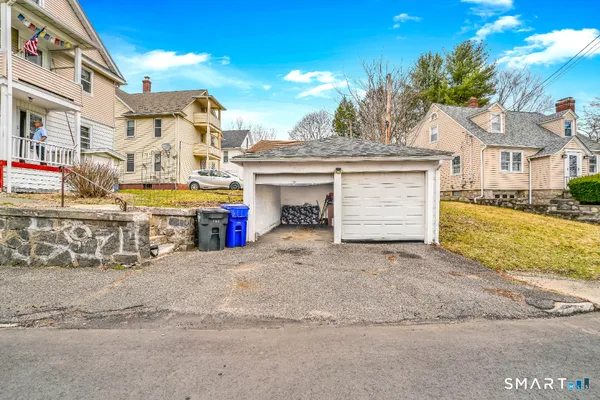 a view of a house with a yard and garage