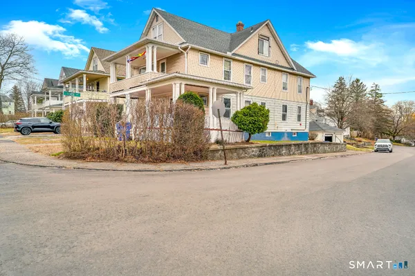 a view of a white house with a street