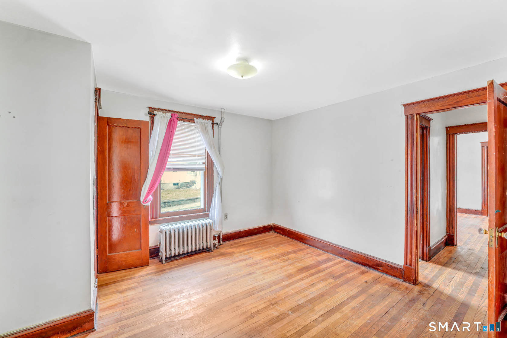 43 Evans Street Torrington, CT 06790 - Photo 6 of 17 an empty room with a window and wooden floor