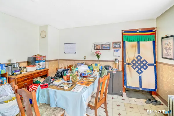 a bedroom with furniture and a lamp