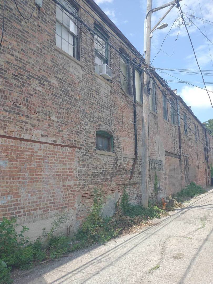 2251 South Troy Street Chicago, IL 60623 - Photo 3 of 7 a brick building with a street