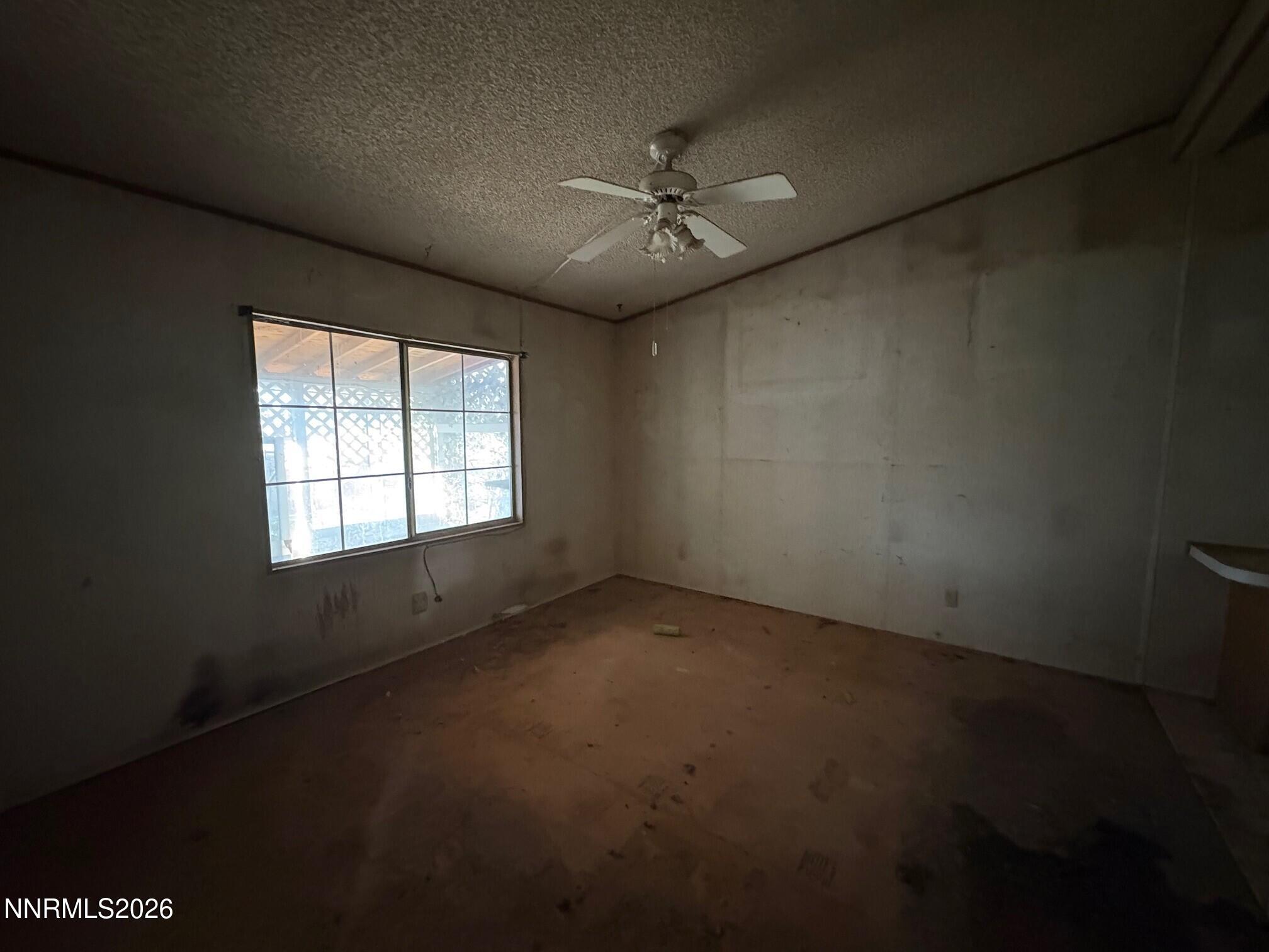 347 Short Avenue Sun Valley, NV 89433 - Photo 16 of 29 an empty room with windows and fan