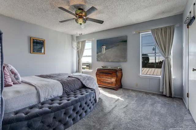 a spacious bedroom with a bed dresser and a window