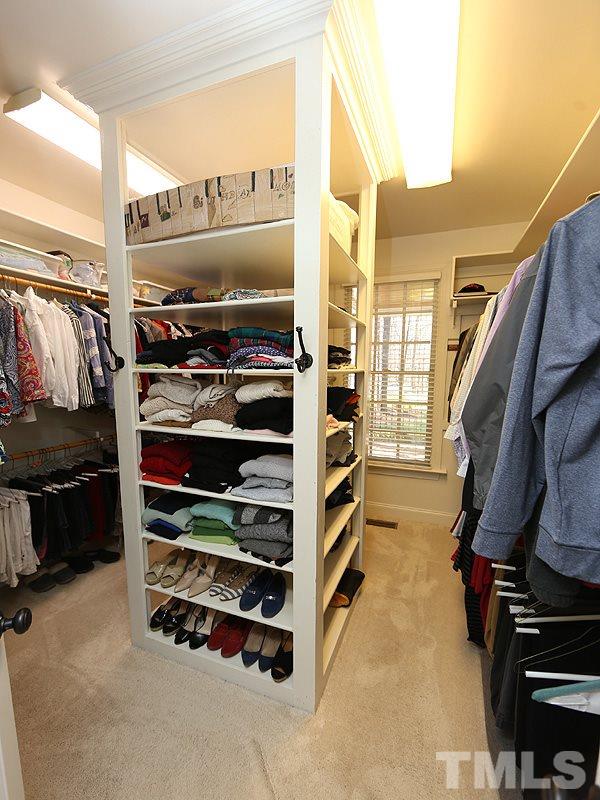 1004 Broken Sound Way Raleigh, NC 27614 - Photo 14 of 25 a view of walk in closet with clothes and shoes