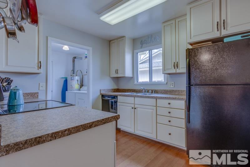 666 Beldon Way Reno, NV 89503 - Photo 8 of 23 a kitchen with granite countertop a refrigerator and a stove top oven