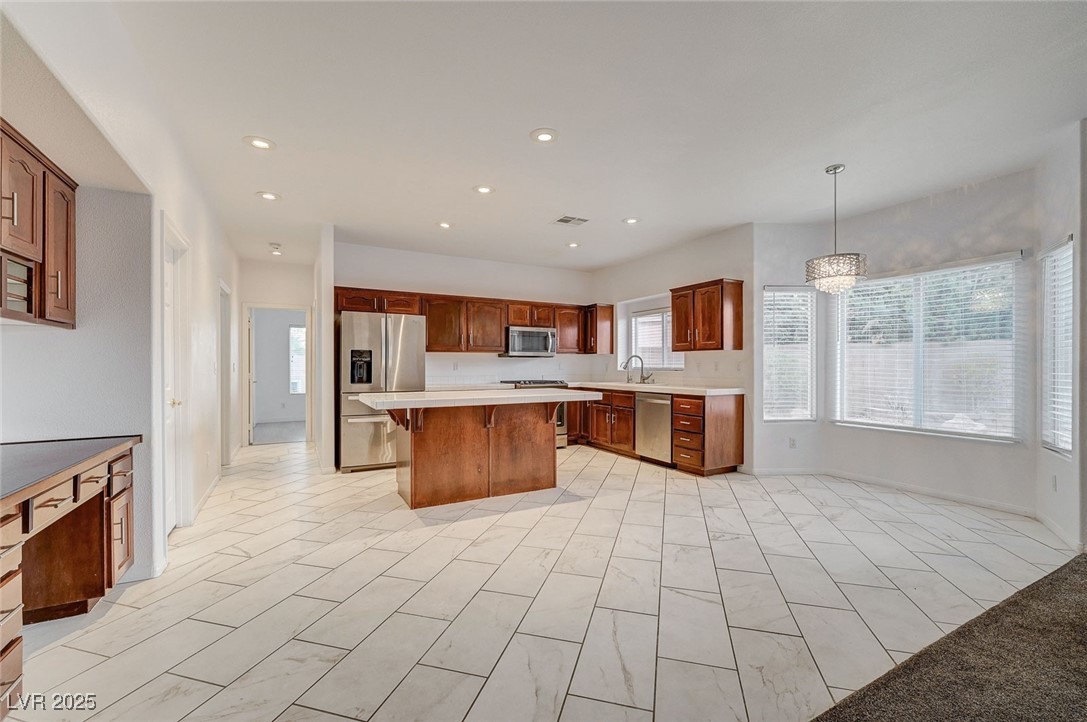 6012 Prospector Trail Las Vegas, NV 89118 - Photo 15 of 73 Kitchen with stainless steel appliances, plenty of natural light, recessed lighting, light countertops, and a kitchen bar