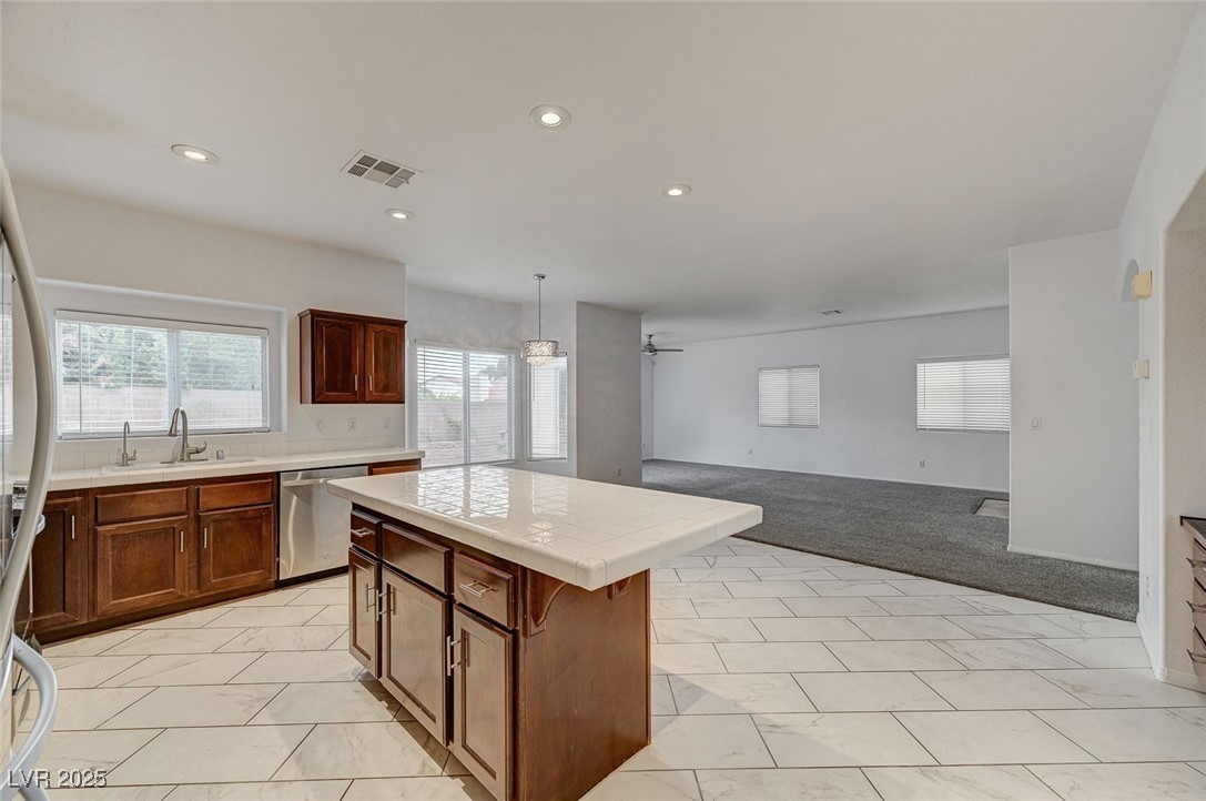 6012 Prospector Trail Las Vegas, NV 89118 - Photo 72 of 73 Kitchen with tile countertops, open floor plan, a center island, stainless steel appliances, and pendant lighting