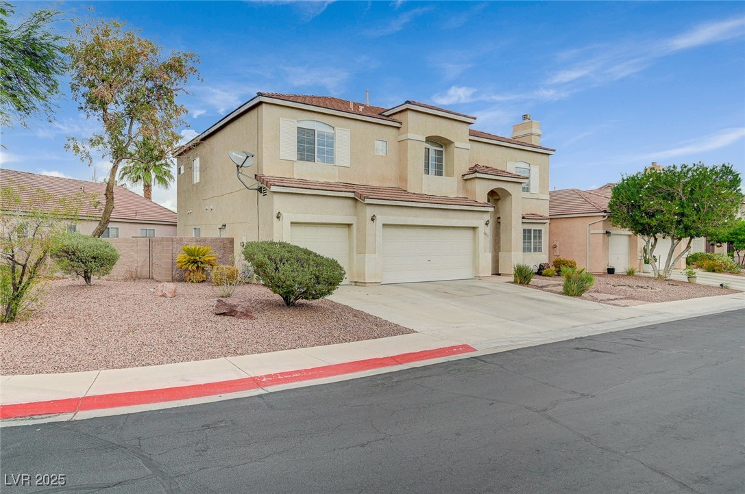 6012 Prospector Trail Las Vegas, NV 89118 - Photo 3 of 73 Mediterranean / spanish house featuring an attached garage, stucco siding, concrete driveway, a chimney, and a tile roof