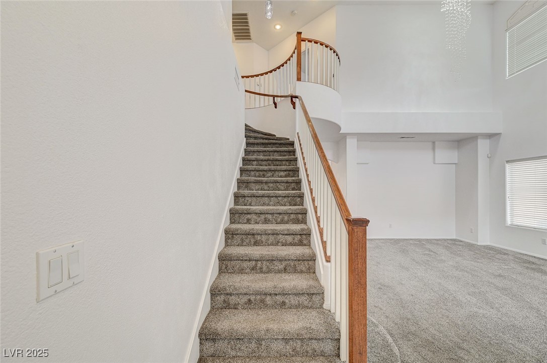 6012 Prospector Trail Las Vegas, NV 89118 - Photo 32 of 73 Stairs featuring a high ceiling and carpet floors