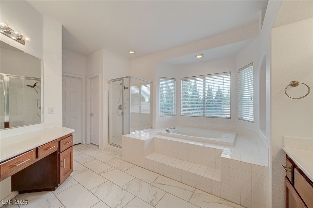 6012 Prospector Trail Las Vegas, NV 89118 - Photo 39 of 73 Bathroom featuring a garden tub, a shower stall, vanity, light marble finish flooring, and recessed lighting
