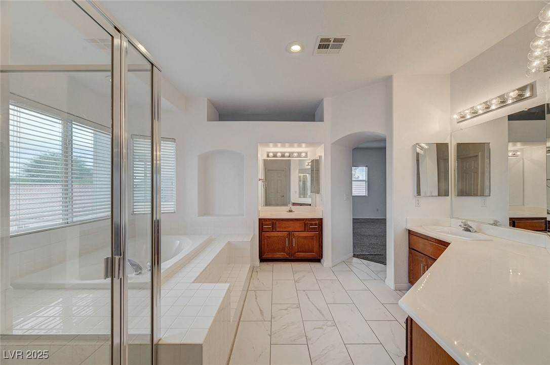 6012 Prospector Trail Las Vegas, NV 89118 - Photo 40 of 73 Bathroom featuring two vanities, a garden tub, a stall shower, and recessed lighting