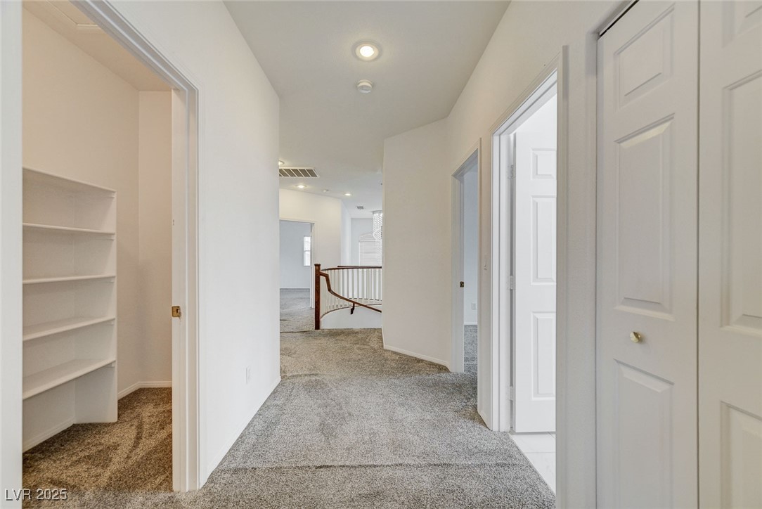 6012 Prospector Trail Las Vegas, NV 89118 - Photo 53 of 73 Hallway with an upstairs landing, light carpet, and recessed lighting