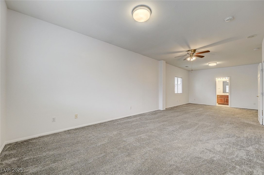 6012 Prospector Trail Las Vegas, NV 89118 - Photo 54 of 73 Carpeted empty room featuring a ceiling fan and baseboards