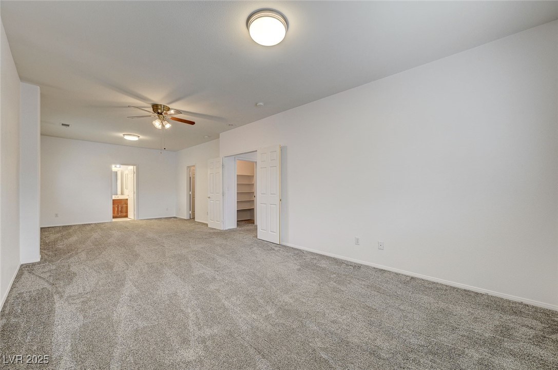 6012 Prospector Trail Las Vegas, NV 89118 - Photo 55 of 73 Carpeted empty room featuring baseboards and ceiling fan