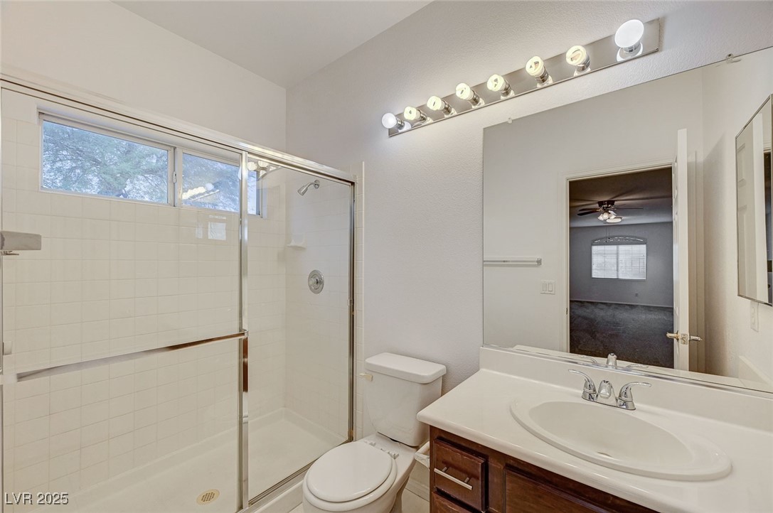 6012 Prospector Trail Las Vegas, NV 89118 - Photo 57 of 73 Bathroom featuring a shower stall, vanity, and ceiling fan