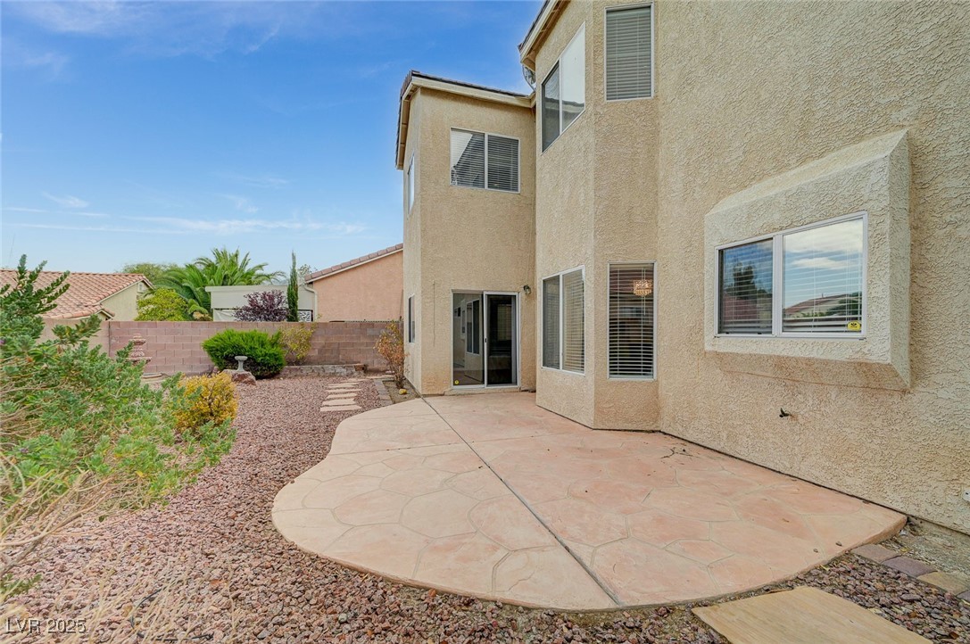 6012 Prospector Trail Las Vegas, NV 89118 - Photo 63 of 73 Rear view of house with a patio area, stucco siding, and a fenced backyard
