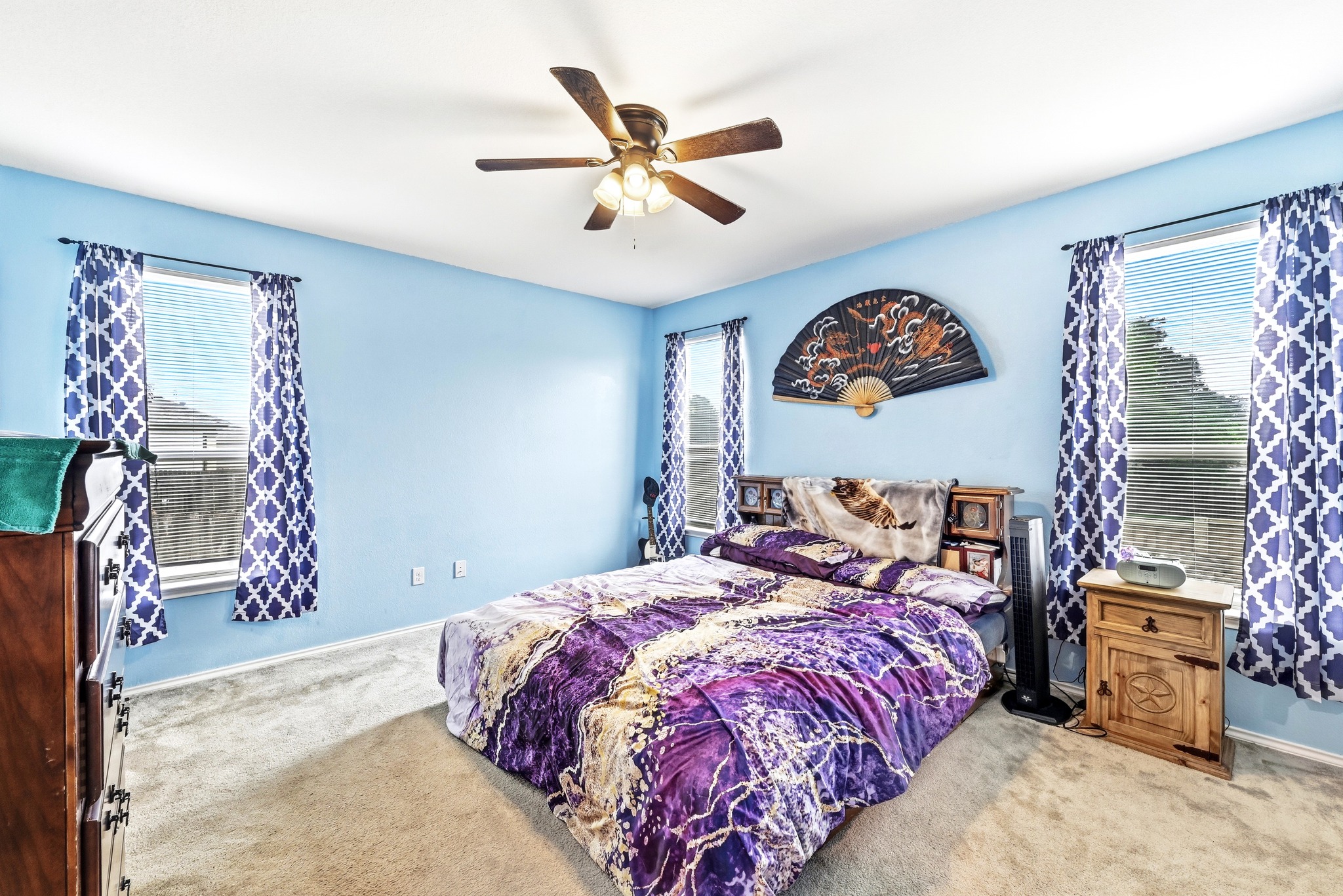 1621 Dragonfly Loop Bastrop, TX 78602 - Photo 15 of 27 Carpeted room featuring light blue walls, multiple windows with blinds, and a ceiling fan with light fixture