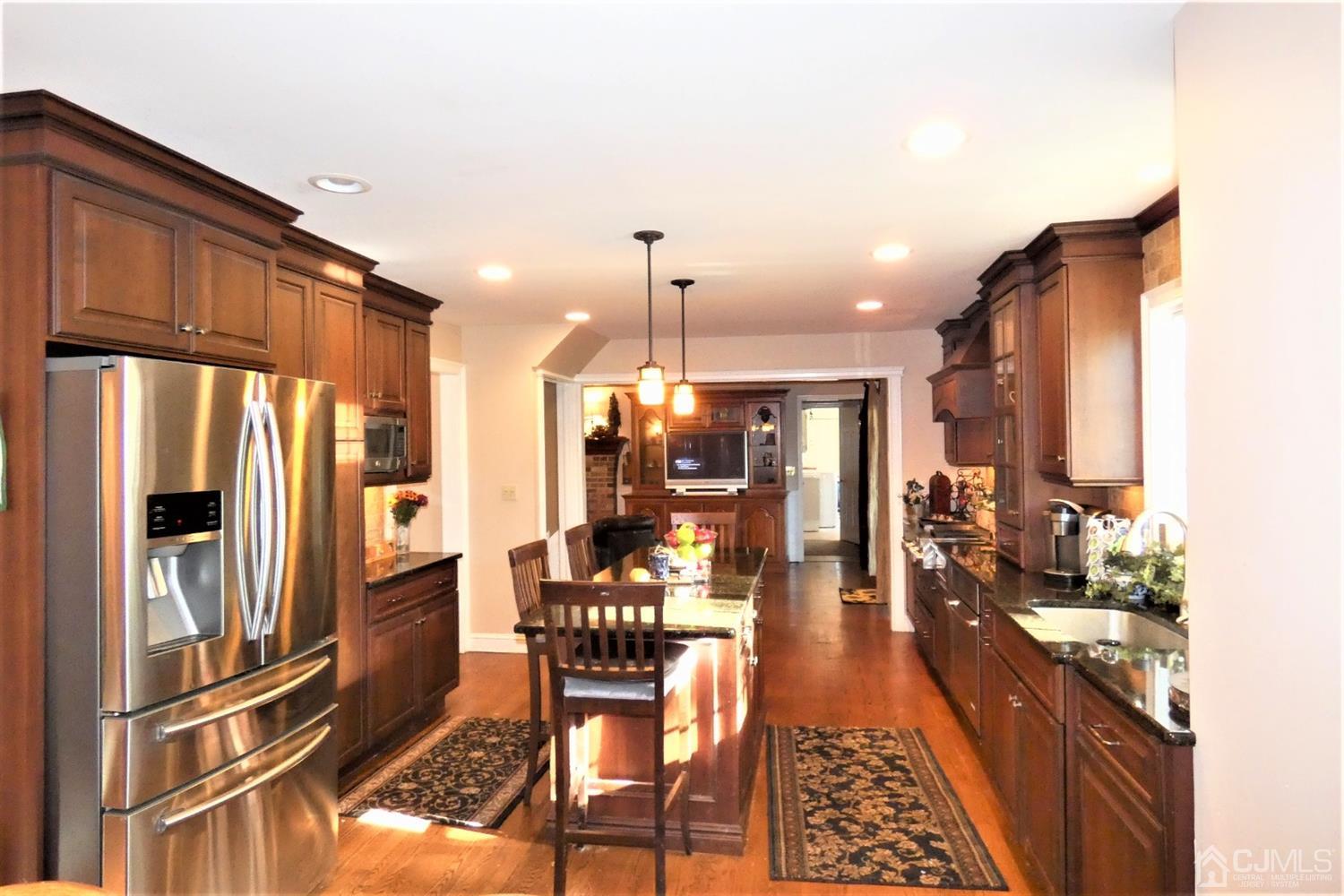 14 Apple Tree Road Flemington, NJ 08822 - Photo 11 of 33 a dining room with stainless steel appliances kitchen island granite countertop a refrigerator a oven a sink with a dining table and chairs