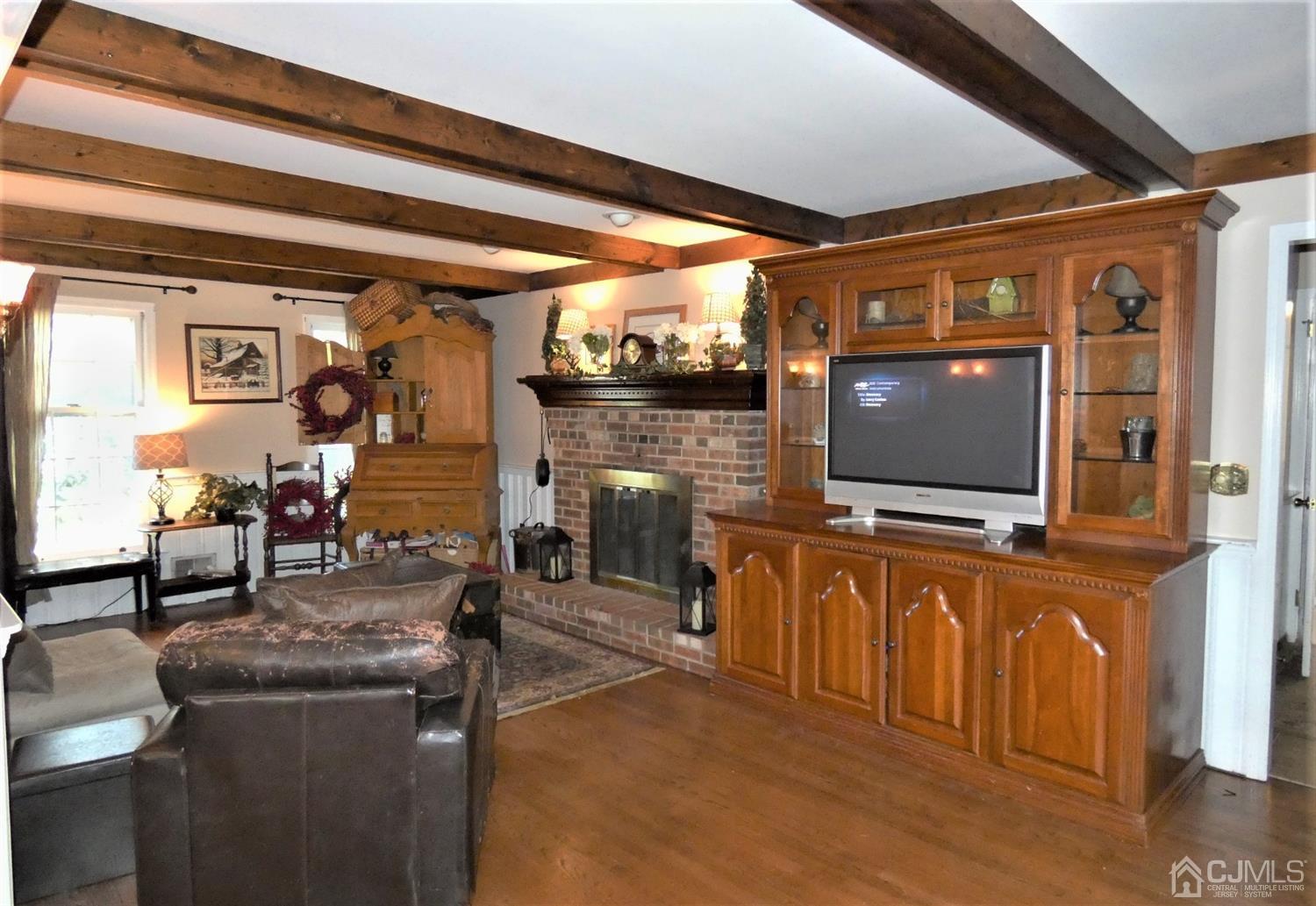 14 Apple Tree Road Flemington, NJ 08822 - Photo 13 of 33 a living room with furniture a flat screen tv and floor to ceiling window