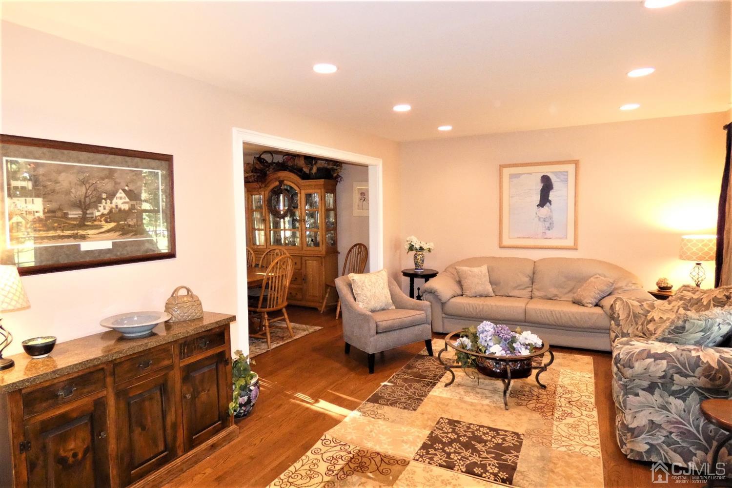 14 Apple Tree Road Flemington, NJ 08822 - Photo 4 of 33 a living room with furniture a rug and a painting on the wall