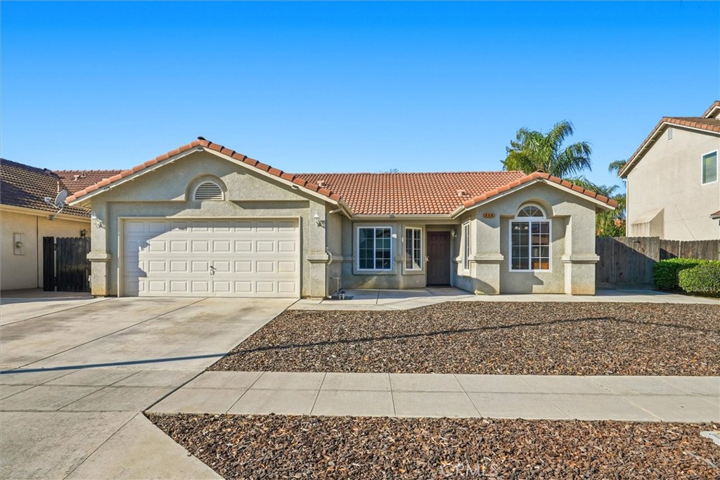 988 Monterey Street Madera, CA 93637 - Photo 1 of 1 a front view of a house with a yard and garage