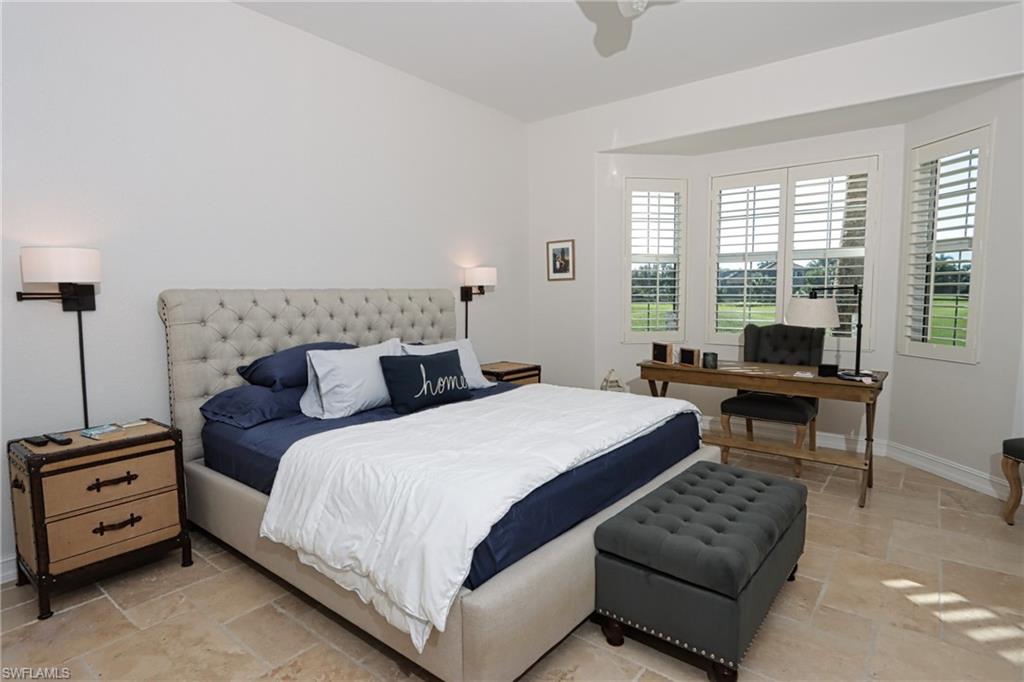 5963 Trophy Drive, Unit 2002 Naples, FL 34110 - Photo 13 of 33 a bedroom with a bed and a couch