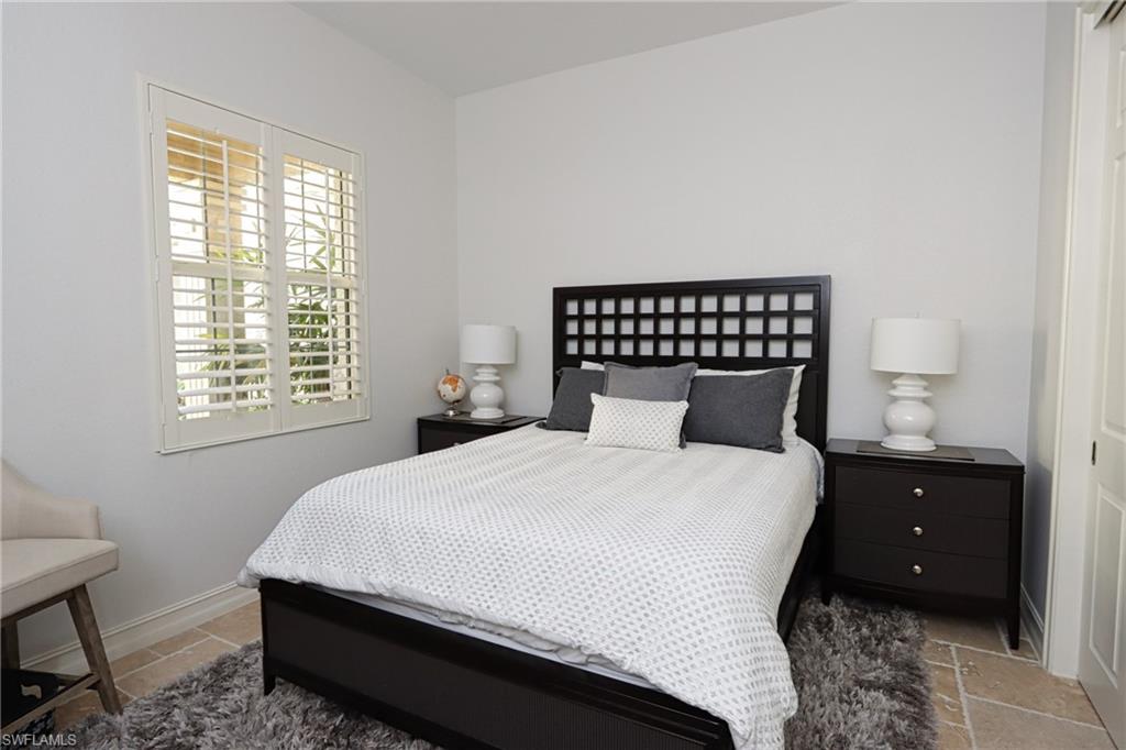 5963 Trophy Drive, Unit 2002 Naples, FL 34110 - Photo 17 of 33 a bedroom with a bed and window