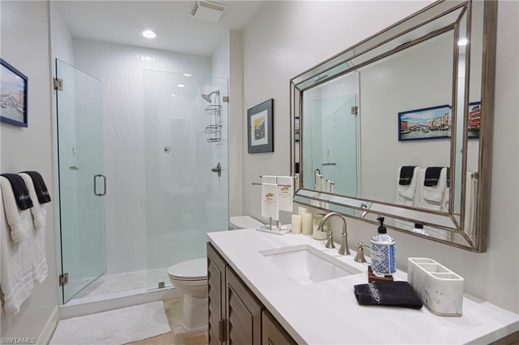5963 Trophy Drive, Unit 2002 Naples, FL 34110 - Photo 19 of 33 a bathroom with a sink a toilet and shower