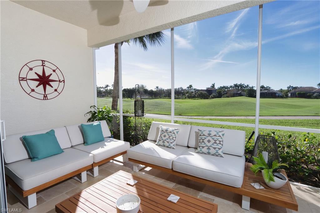 5963 Trophy Drive, Unit 2002 Naples, FL 34110 - Photo 2 of 33 a living room with furniture and a floor to ceiling window