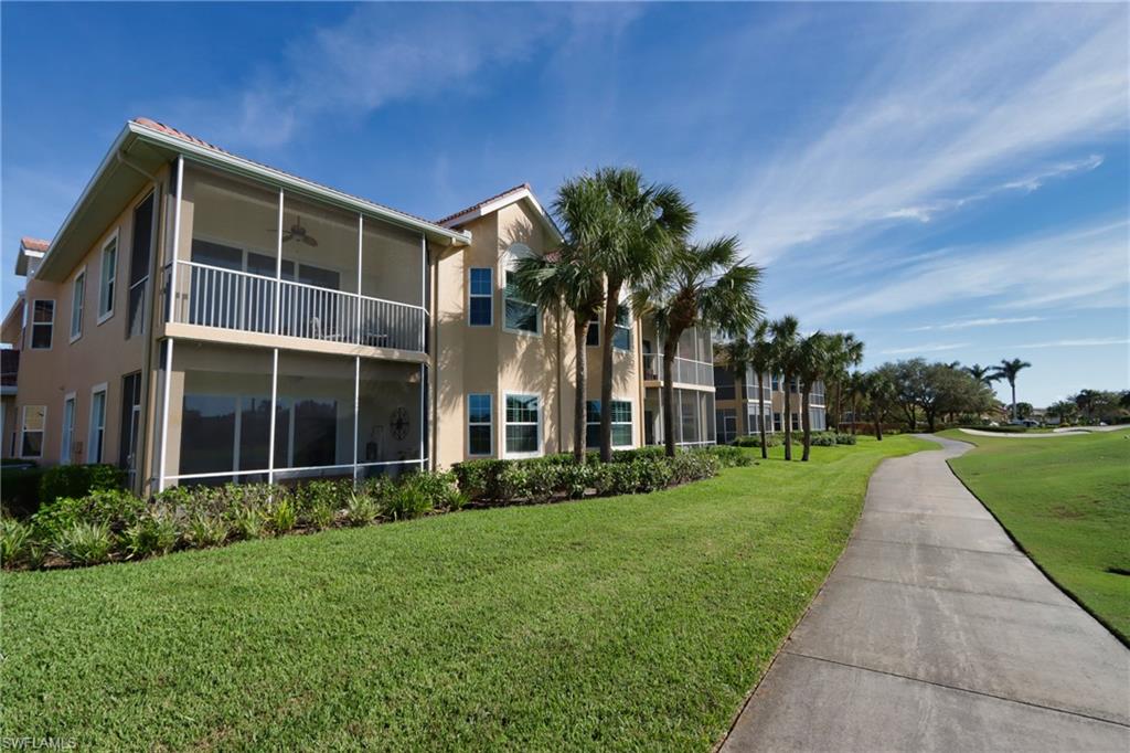 5963 Trophy Drive, Unit 2002 Naples, FL 34110 - Photo 25 of 33 a front view of house with yard and green space