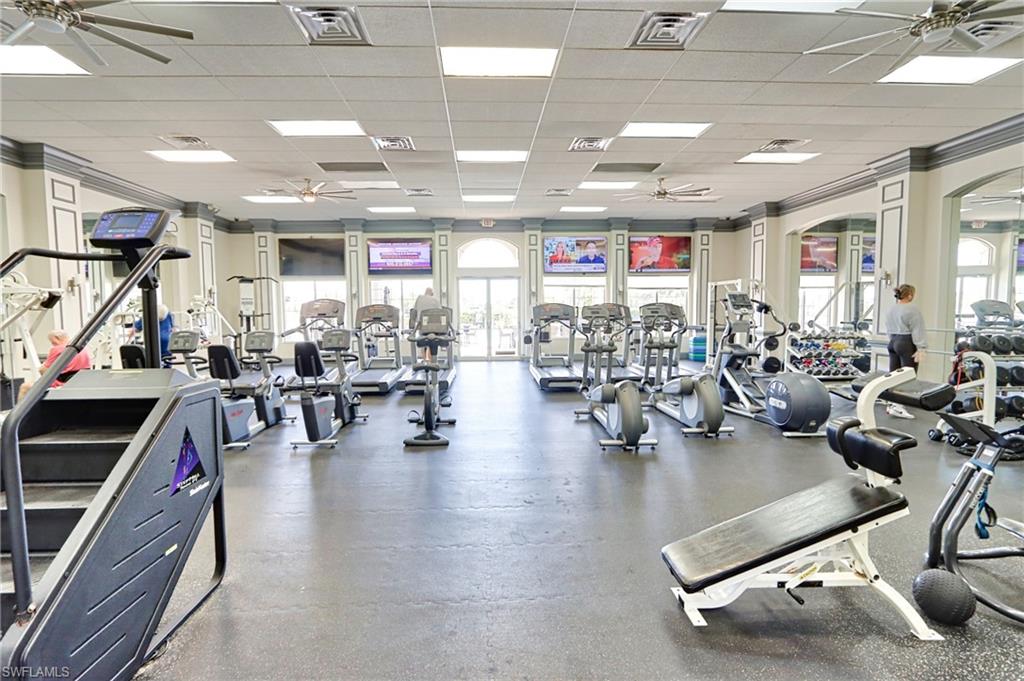 5963 Trophy Drive, Unit 2002 Naples, FL 34110 - Photo 26 of 33 a gym room with lots of gym equipment
