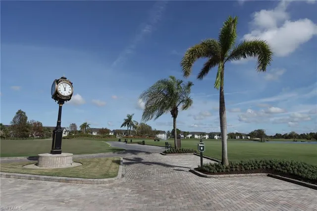 a park with water view and palm trees