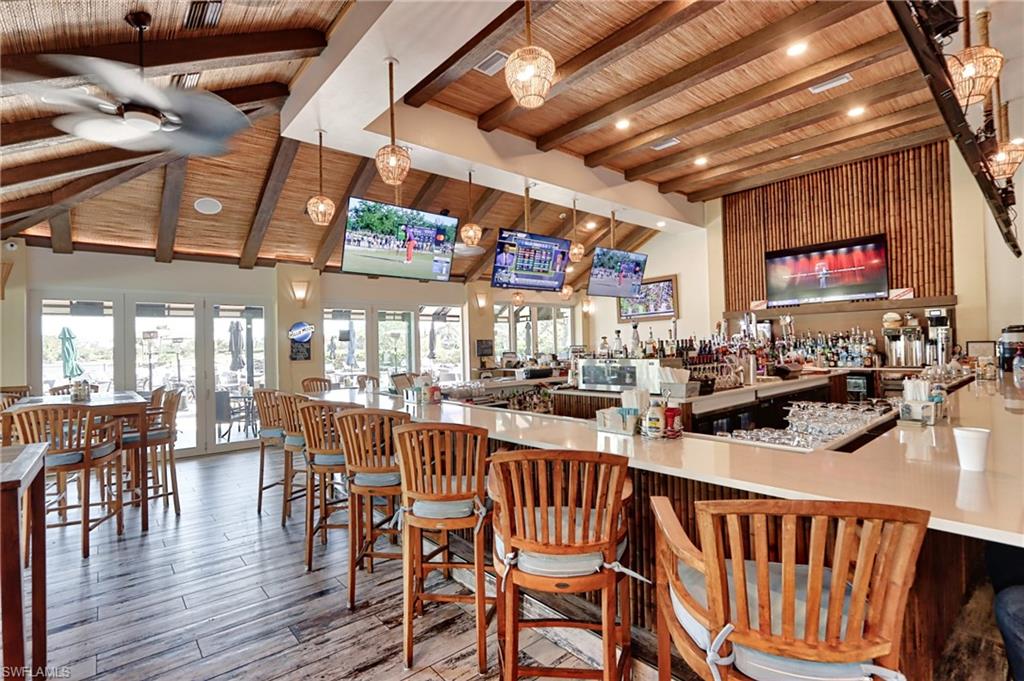 5963 Trophy Drive, Unit 2002 Naples, FL 34110 - Photo 29 of 33 a view of a dining room with furniture wooden floor and chandelier