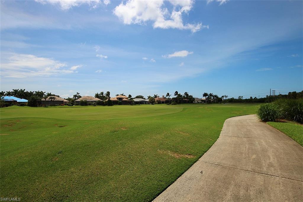 5963 Trophy Drive, Unit 2002 Naples, FL 34110 - Photo 3 of 33 a view of a golf course with a lake