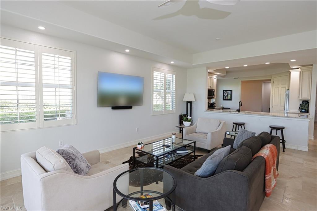 5963 Trophy Drive, Unit 2002 Naples, FL 34110 - Photo 6 of 33 a living room with furniture and a flat screen tv