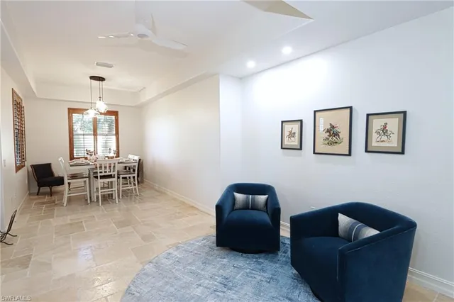a living room with furniture and a dining room