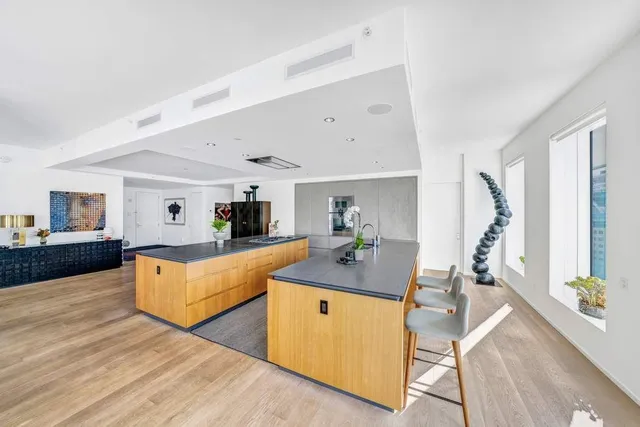 a living room with furniture a flat screen tv and wooden floor