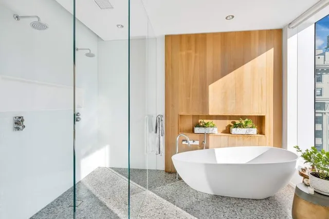 a large white room with mirror and windows