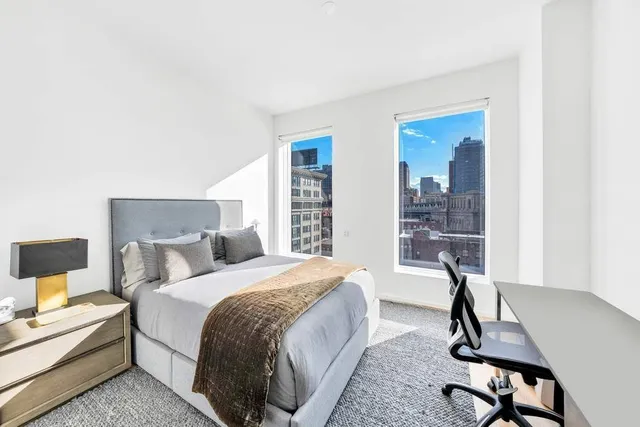 a bathroom with a toilet sink vanity and mirror