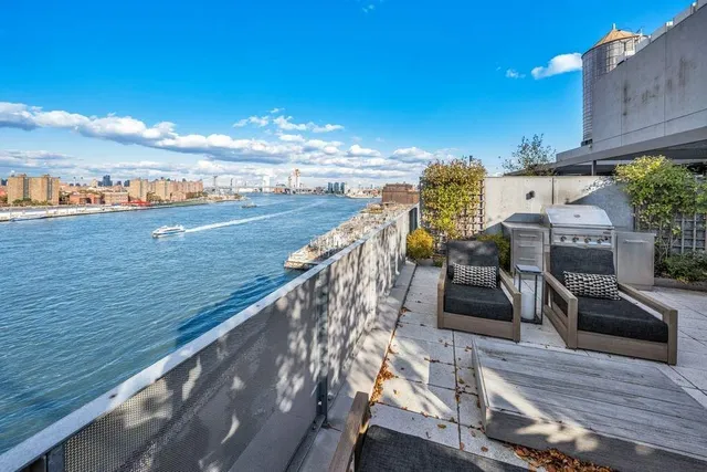 a view of a balcony with floor to ceiling windows and wooden floor