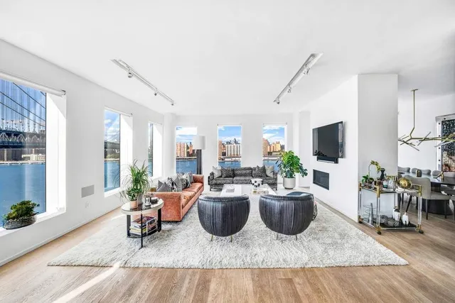 a living room with furniture and a floor to ceiling window